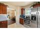 Cozy kitchen with stainless steel appliances, wood cabinets, and a tiled floor at 4779 S Bannock St, Englewood, CO 80110