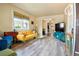 Cozy living room with hardwood floors, a yellow sofa, and stylish decor at 4779 S Bannock St, Englewood, CO 80110