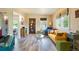 Bright living room with hardwood floors, a yellow couch, and a colorful accent cabinet at 4779 S Bannock St, Englewood, CO 80110