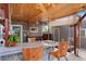 Covered outdoor kitchen features a stone bar, butcher block and seating, perfect for entertaining and dining at 4779 S Bannock St, Englewood, CO 80110