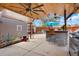 This outdoor space has a covered outdoor kitchen with bar and grill area, and a fire pit at 4779 S Bannock St, Englewood, CO 80110