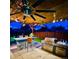 Outdoor kitchen with stone accents, grill, and seating area at 4779 S Bannock St, Englewood, CO 80110