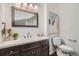 Bright bathroom with a wood vanity, modern light fixtures, and stylish accents at 2426 S Acoma St, Denver, CO 80223