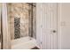 Well-lit bathroom featuring a shower-tub combo with decorative tile and a shower curtain at 2426 S Acoma St, Denver, CO 80223