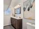 Chic bathroom with a wood vanity, modern light fixtures, and stylish accents at 2426 S Acoma St, Denver, CO 80223