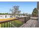 Open-air deck showcasing wood floors and railings with a view of neighborhood buildings at 2426 S Acoma St, Denver, CO 80223