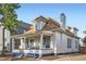 Quaint two-story home showcasing a front porch, clean lines, and inviting curb appeal at 2426 S Acoma St, Denver, CO 80223