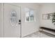 Bright foyer featuring stylish flooring, a decorative door, and a modern bench at 2426 S Acoma St, Denver, CO 80223