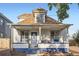 Charming home showcasing a cozy front porch and blue and white exterior paint at 2426 S Acoma St, Denver, CO 80223