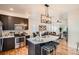 Open-concept kitchen with a large island, modern appliances, and ample counter space at 2426 S Acoma St, Denver, CO 80223
