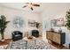 Bright and stylish living room with plenty of natural light and a patterned area rug at 2426 S Acoma St, Denver, CO 80223