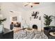 Cozy living room with a decorative fireplace, modern art, and an adjacent sitting area at 2426 S Acoma St, Denver, CO 80223