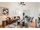 Bright living room with leather sofa, contemporary rug, and plenty of natural light at 2426 S Acoma St, Denver, CO 80223