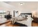 Spacious main bedroom featuring wood floors, large bed, and a seating area at 2426 S Acoma St, Denver, CO 80223
