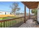 Covered patio with wooden posts and a railing overlooking a grassy yard and wooden fence at 2426 S Acoma St, Denver, CO 80223