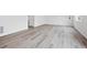 Unfinished basement with light wood floors, neutral walls, recessed lighting, and a door on the back wall at 45921 Wood Thrush Ave, Bennett, CO 80102