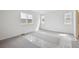 Bedroom featuring new carpeting and two windows, creating a bright space at 45921 Wood Thrush Ave, Bennett, CO 80102