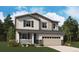Charming two-story home featuring a covered porch, attached two-car garage, and professionally landscaped yard at 45921 Wood Thrush Ave, Bennett, CO 80102