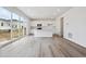 Open-concept kitchen with sleek white cabinets, stainless steel appliances, and a large island at 45921 Wood Thrush Ave, Bennett, CO 80102
