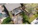 Aerial view of the home showcasing the large deck, green lawn, and mature trees in the backyard at 13131 Pennsylvania St, Thornton, CO 80241