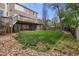 Spacious backyard with a stone border, lush lawn, and an upper level deck at 13131 Pennsylvania St, Thornton, CO 80241