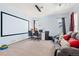 Finished basement featuring a large projector screen, workspace, and comfortable seating area, perfect for entertainment at 13131 Pennsylvania St, Thornton, CO 80241
