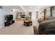 Finished basement featuring a large sectional couch, a TV, and a kitchenette with bar seating at 13131 Pennsylvania St, Thornton, CO 80241