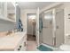 Bathroom with a step-in shower, vanity with one sink, and neutral color palette at 13131 Pennsylvania St, Thornton, CO 80241
