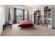 Cozy bedroom featuring a large window, bookshelves, and comfortable beanbag seating at 13131 Pennsylvania St, Thornton, CO 80241