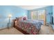 Cozy bedroom with bright blue walls, windows for ample light, and neutral carpet flooring at 13131 Pennsylvania St, Thornton, CO 80241
