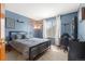 Cozy bedroom with blue walls, natural light, and modern decor provides a restful retreat at 13131 Pennsylvania St, Thornton, CO 80241