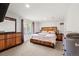 Bright bedroom featuring light carpet, a wooden bed frame, and a dresser with ample storage at 13131 Pennsylvania St, Thornton, CO 80241