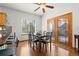 Bright dining room with hardwood floors, black marble dining table, and beautiful wooden French doors to the outside deck at 13131 Pennsylvania St, Thornton, CO 80241