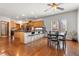 Open kitchen with stainless appliances, wood cabinets, breakfast bar, and adjacent dining area with black marble table at 13131 Pennsylvania St, Thornton, CO 80241
