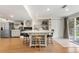Stylish kitchen island with seating, stainless appliances, and easy access to backyard at 13131 Pennsylvania St, Thornton, CO 80241