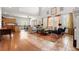 Open-concept living room features hardwood floors, high ceilings, and seamless flow into dining and kitchen areas at 13131 Pennsylvania St, Thornton, CO 80241