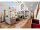 Open-concept living room featuring high ceilings, a fireplace with custom shelving, and large windows for natural light at 13131 Pennsylvania St, Thornton, CO 80241