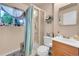 Bright bathroom featuring a glass-enclosed shower, stylish vanity, and patterned flooring at 10972 Fairfax Ct, Thornton, CO 80233