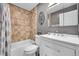 Bathroom featuring a shower-tub combo, tiled walls and floors, and a modern sink at 10972 Fairfax Ct, Thornton, CO 80233
