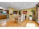 Bright dining room features hardwood floors and a view into the kitchen at 10972 Fairfax Ct, Thornton, CO 80233