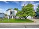 Charming two-story home with a manicured lawn and mature tree offering curb appeal at 10972 Fairfax Ct, Thornton, CO 80233