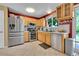 Bright kitchen featuring stainless steel appliances and ample cabinet space at 10972 Fairfax Ct, Thornton, CO 80233