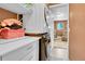 Efficient laundry area with stacked washer and dryer units and convenient shelving for storage at 10972 Fairfax Ct, Thornton, CO 80233