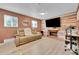 Inviting living room with fireplace, comfortable sofa, and two bright windows for ample natural light at 10972 Fairfax Ct, Thornton, CO 80233