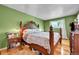 Spacious main bedroom with green walls, hardwood floors, and vintage furniture at 10972 Fairfax Ct, Thornton, CO 80233