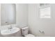 Simple bathroom with white sink, toilet and mirror at 13372 E 110Th Way, Commerce City, CO 80022