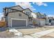 Two-story house with stone and gray siding, two-car garage at 13372 E 110Th Way, Commerce City, CO 80022