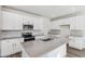 Modern kitchen with white cabinets and a large island at 13372 E 110Th Way, Commerce City, CO 80022