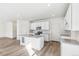 Modern kitchen with white cabinets, gray countertops, and island at 13372 E 110Th Way, Commerce City, CO 80022