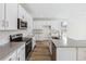 Modern kitchen with white cabinets, gray countertops, and island at 13372 E 110Th Way, Commerce City, CO 80022